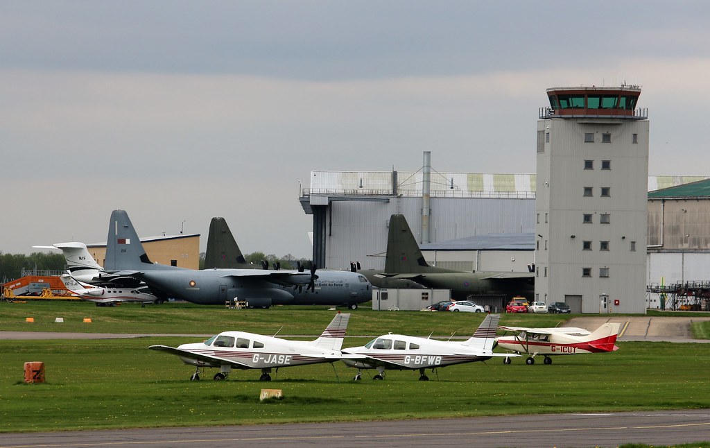 Cambridge Airport control tower with parked aircraft on the apron