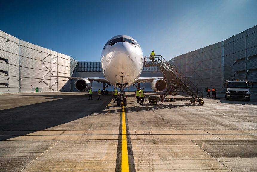 Large commercial jet undergoing maintenance at Cambridge Airport's Marshall hangars