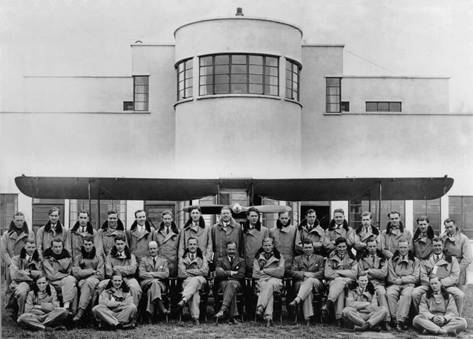 1929 group photograph of pilots and staff in front of the original Art Deco terminal building